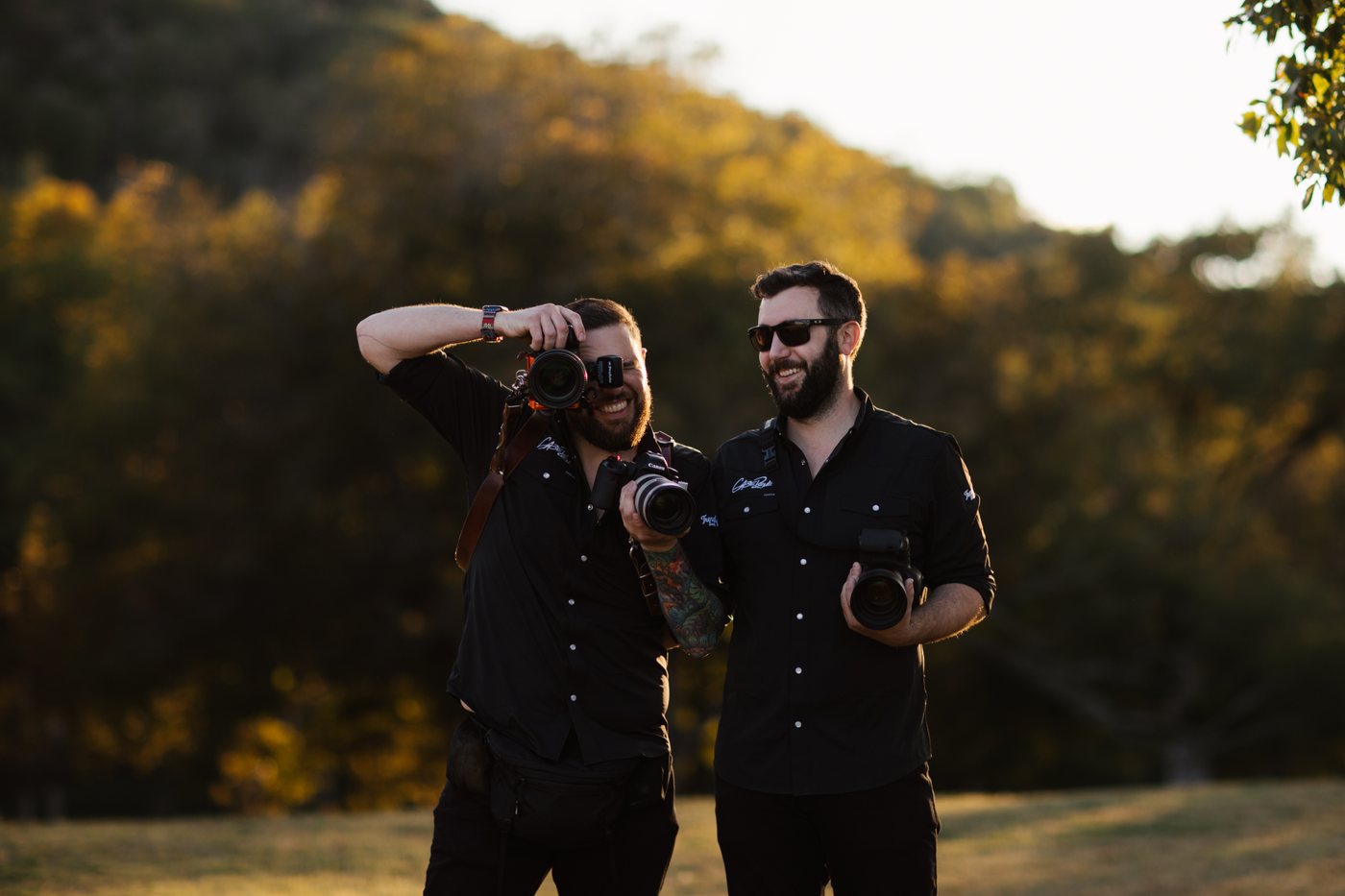 Gabe and Kyle of GR Weddings shooting at golden hour in Hunt, Texas, both carrying Canon bodies