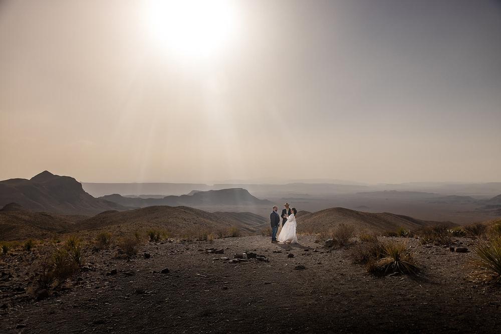 A couple eloping at Sotol Vista Overlook inside Big Bend National Park with a West Texas dust storm blowing in creating a stunning backdrop