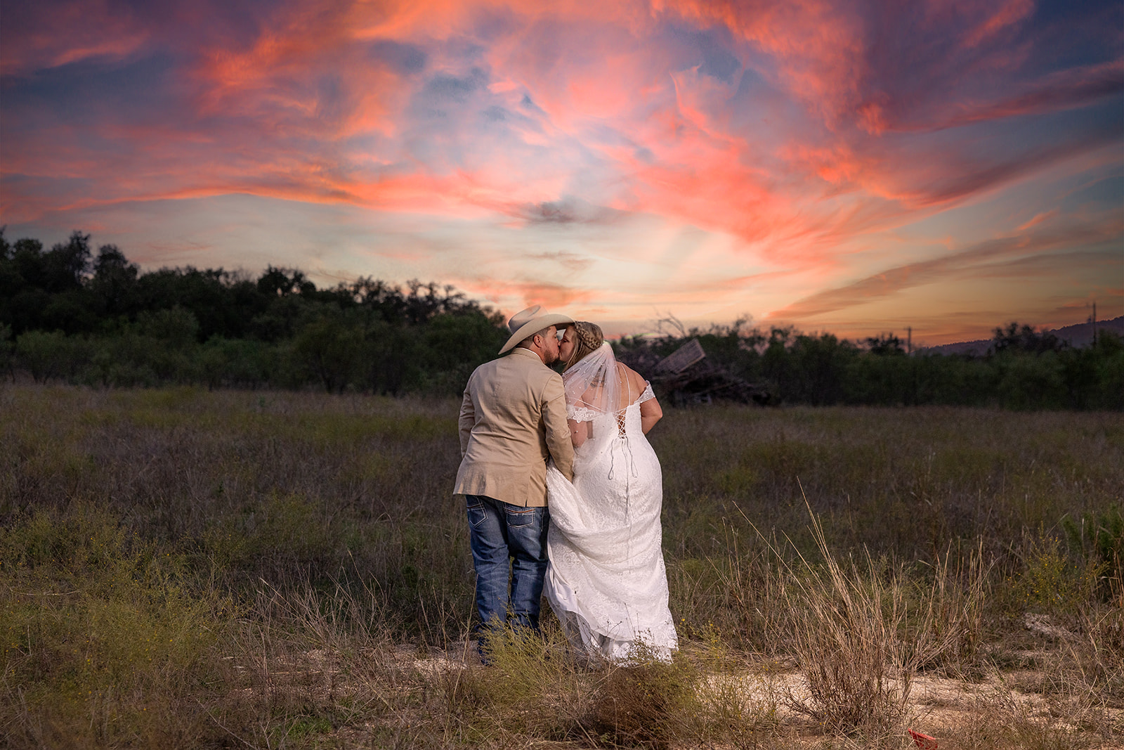 Couple at sunset under a Hill Country sky by GR Weddings
